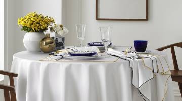 Dining set on a round table with a white table cloth